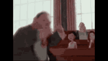a blurry picture of a man talking to a group of people