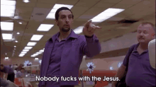 a man in a purple shirt says nobody fucks with jesus