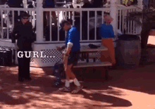 a man in a blue shirt is standing in front of a gazebo with the word gurl written on the side