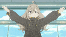 a girl in a black jacket is standing with her arms outstretched in front of a window