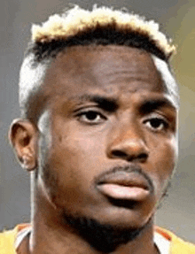 a close up of a soccer player 's face with a beard and blonde hair .