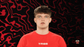 a young man wearing a red shirt that says tribe