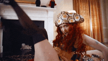 a woman with red hair is wearing a hat with a floral pattern