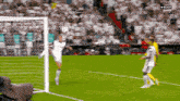 a soccer player kicks a ball into the goal during a game