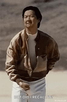 a man in a brown jacket is holding a golf club and making a face .