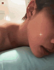a close up of a person laying on a bed