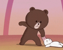 a brown teddy bear is holding a white rabbit 's ear .