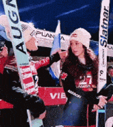 a woman stands in front of a sign that says plan a