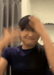 a blurry picture of a person holding their hair