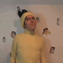 a man wearing a yellow sweater and a yellow hat
