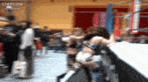 a blurry picture of a wrestling match with the word stardom on the bottom right
