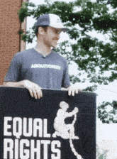 a man holding a sign that says equal rights on it