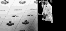 a black and white photo of people standing in front of a wall that says mbc media
