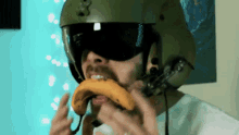 a man wearing a helmet eating a banana