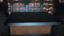 a dark room with a table and a sign that says ' a & a ' on it