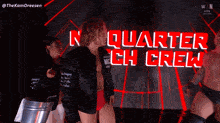 a man in a black jacket is standing in front of a sign that says quarter crew