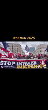 a group of people holding a banner that says stop inwazji