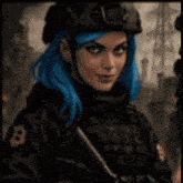 a woman with blue hair and a helmet is holding a gun .