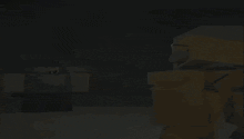 a man and a yellow robot are standing next to each other in a dark room
