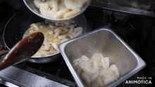 a pan of shrimp is being poured into a pan next to a container of shrimp made in animatica