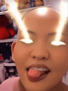 a close up of a woman 's face with her tongue out