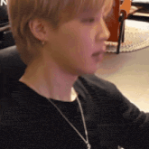 a close up of a person 's face with a necklace around their neck