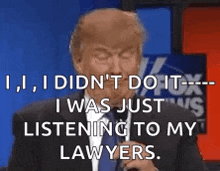 a man in a suit and tie is talking into a microphone and saying i did n't do it .