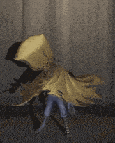 a person wearing a yellow cape with a pillow on their head
