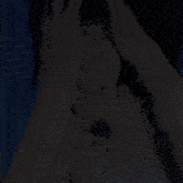 a man is covering his face with his hands and screaming .