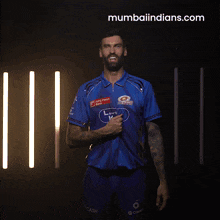 a man in a blue mumbai indians jersey