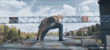 a man leaps over a bridge with nandamurifans.com written on the bottom right