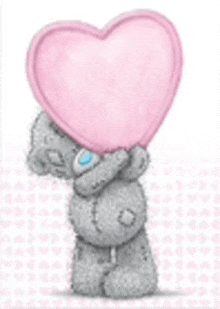 a teddy bear is holding a pink heart over its face .