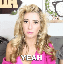 a woman in a pink top says yeah in white letters