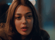 a close up of a woman 's face with a blurred background