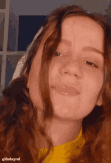a close up of a woman 's face with the words gifsdayrol below