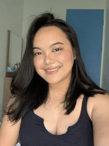 a woman taking a selfie with a blue door in the background