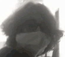 a close up of a person 's face with smoke coming out of their mouth and nose .