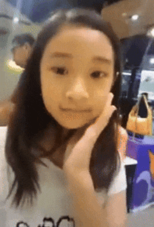 a girl with long hair wearing a white shirt that says gucci