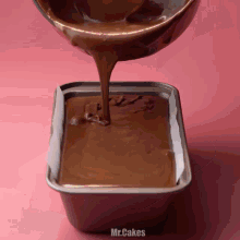 chocolate is being poured into a loaf pan with the words mr.cakes written on the bottom