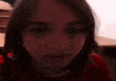 a close up of a woman wearing a red shirt .