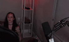 a woman is sitting in front of a microphone in a room