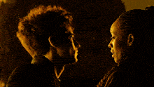 a man and a woman are kissing each other in a dark room .