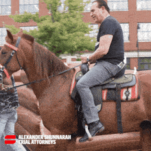 a man riding a brown horse with the name alexander shunnarah on the bottom
