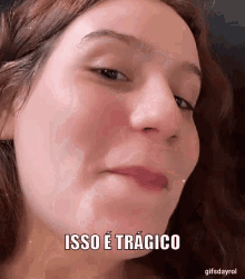 a close up of a woman 's face with the words isso e tragico written on it