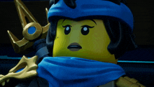 a close up of a lego figure with a blue scarf around her neck