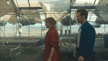 a man and a woman are standing in a greenhouse with the hashtag #abigbold beautiful journey