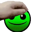 a hand is touching a green smiley face with a towel .