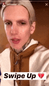 a picture of a man with a tear coming out of his eye and the words swipe up on the bottom