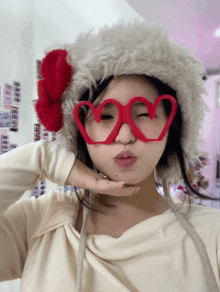 a woman wearing heart shaped glasses and a furry hat