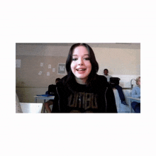a girl in a classroom wearing a shirt that says " limbo "